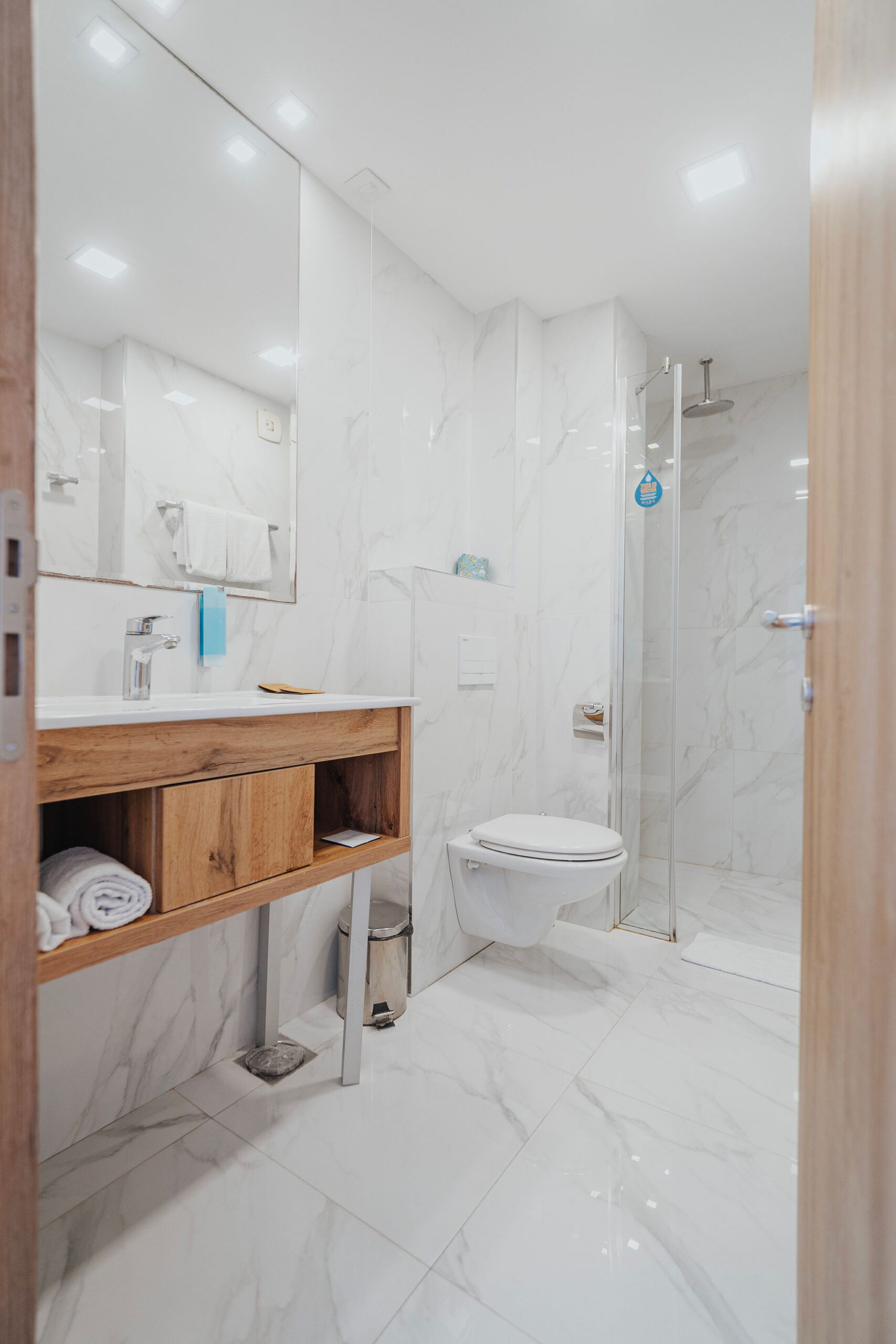 a hotel room bathroom in white