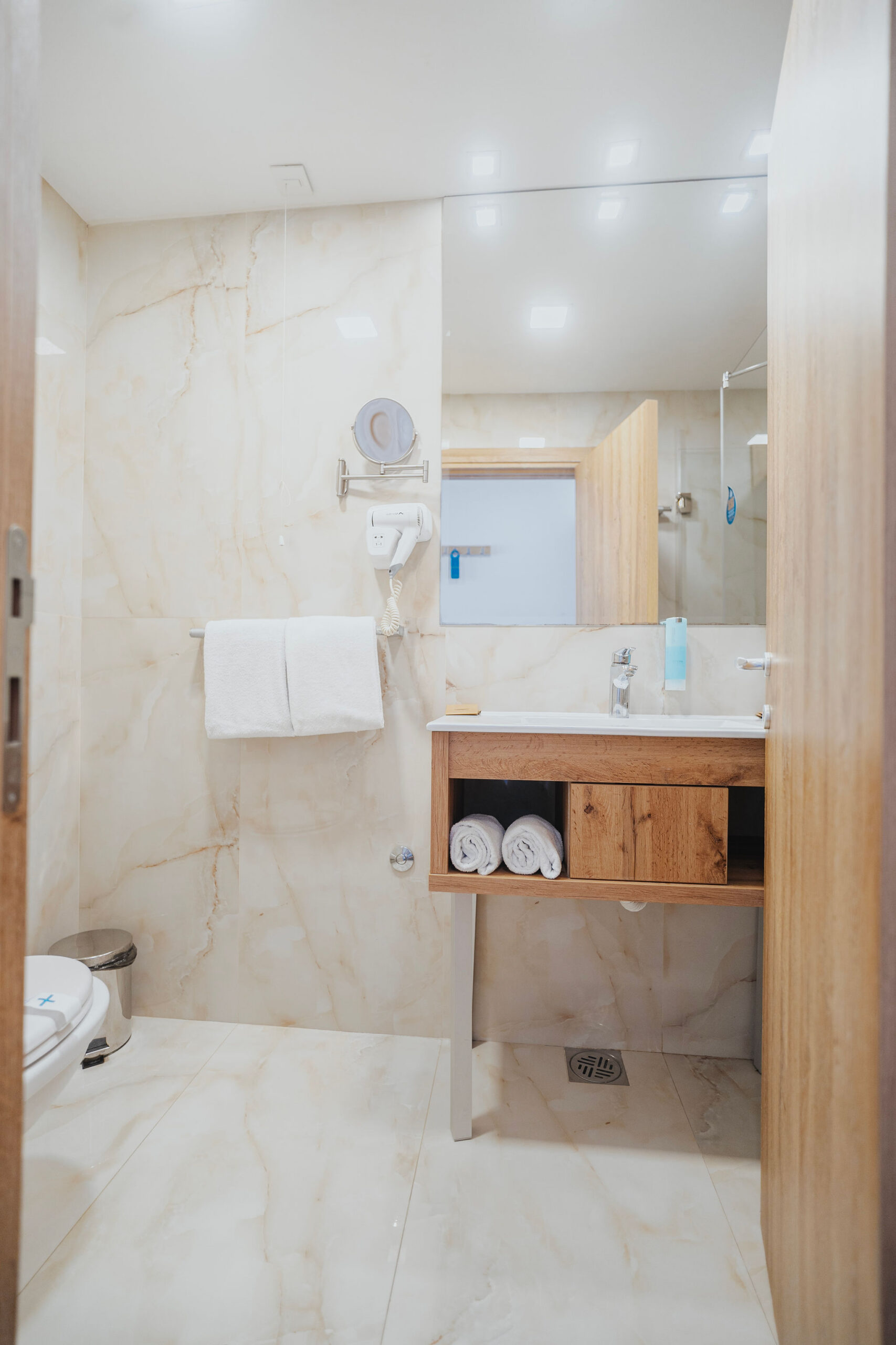 white hotel bathroom with a mirror