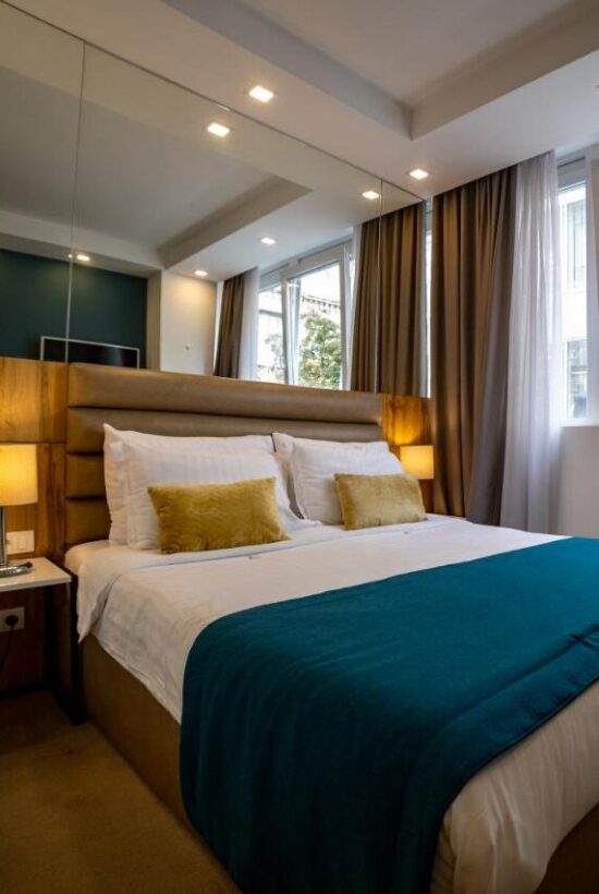 a queen sized bed with a mirror behind it